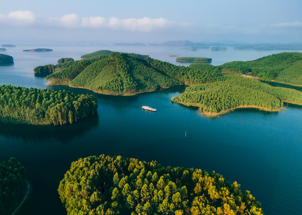 A tranquil island rises from the misty waters of Thac Ba Lake